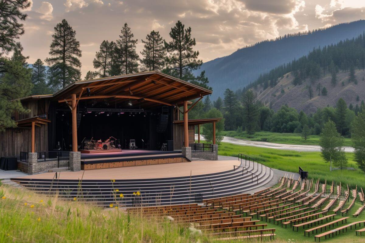 An amphitheater with a stage and chairs beside a river in Montana.