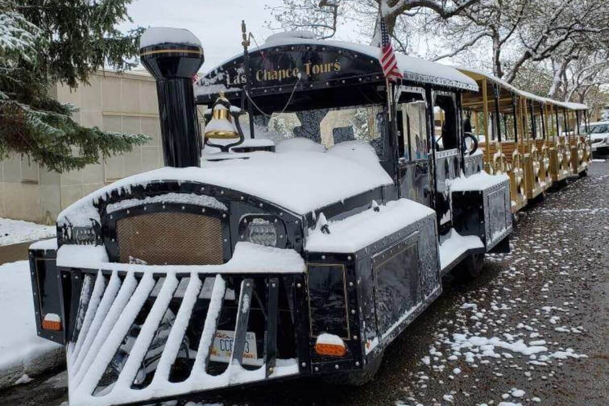 The Last Chance Tour train covered in snow, great for Montana train tours.