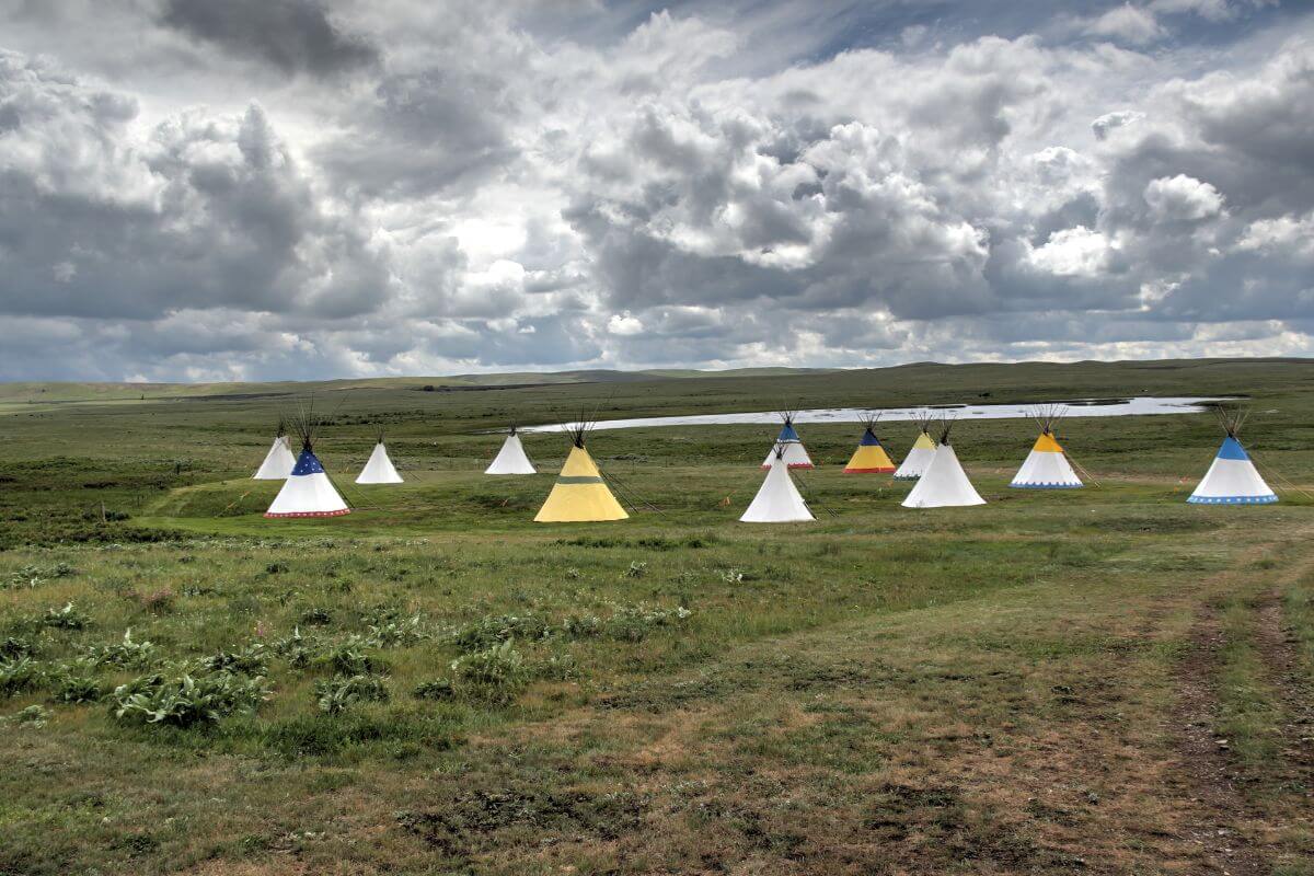 A group of colorful teepees in a grassy field in Montana.