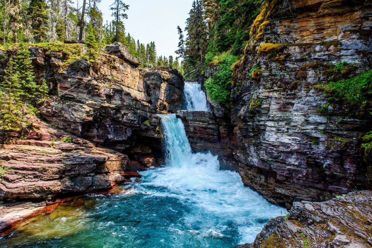 A captivating waterfall nestled within the scenic beauty of a rocky canyon in Montana.