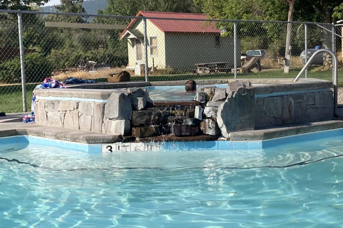 A small hot spring pool that empties into a larger pool in Symes Hot Springs in Montana