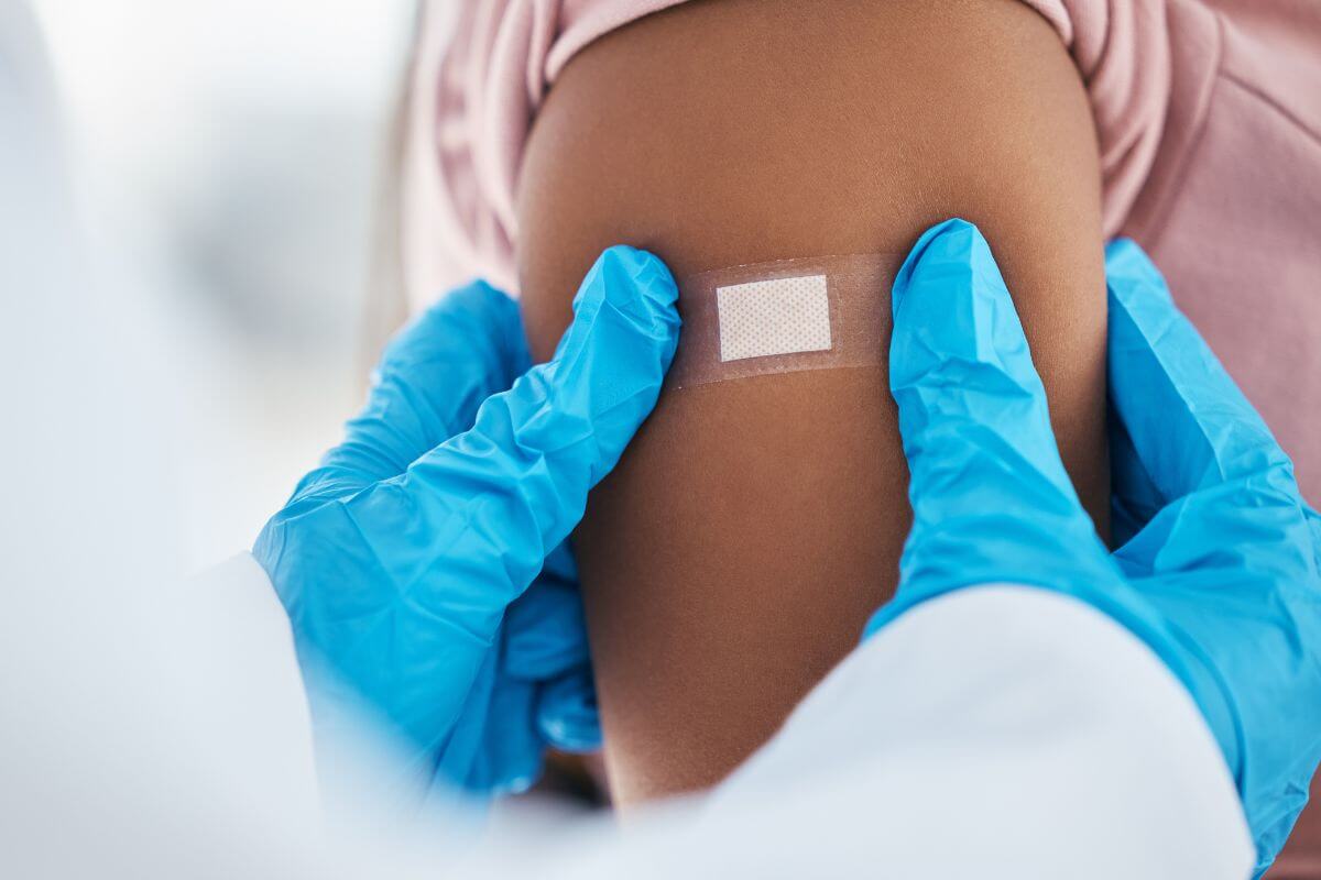 A woman in Montana is getting a COVID vaccine on her arm.