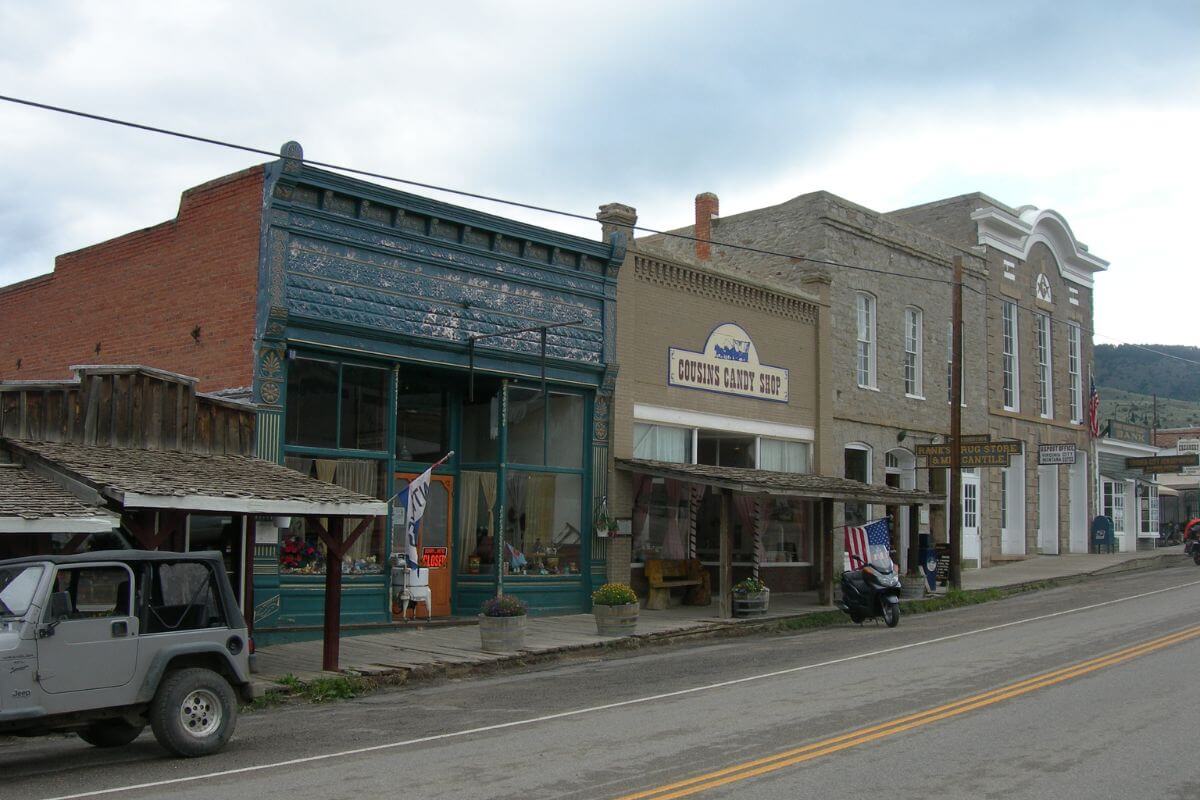 Buildings in a quiet town in Montana, with a jeep parked along the road.