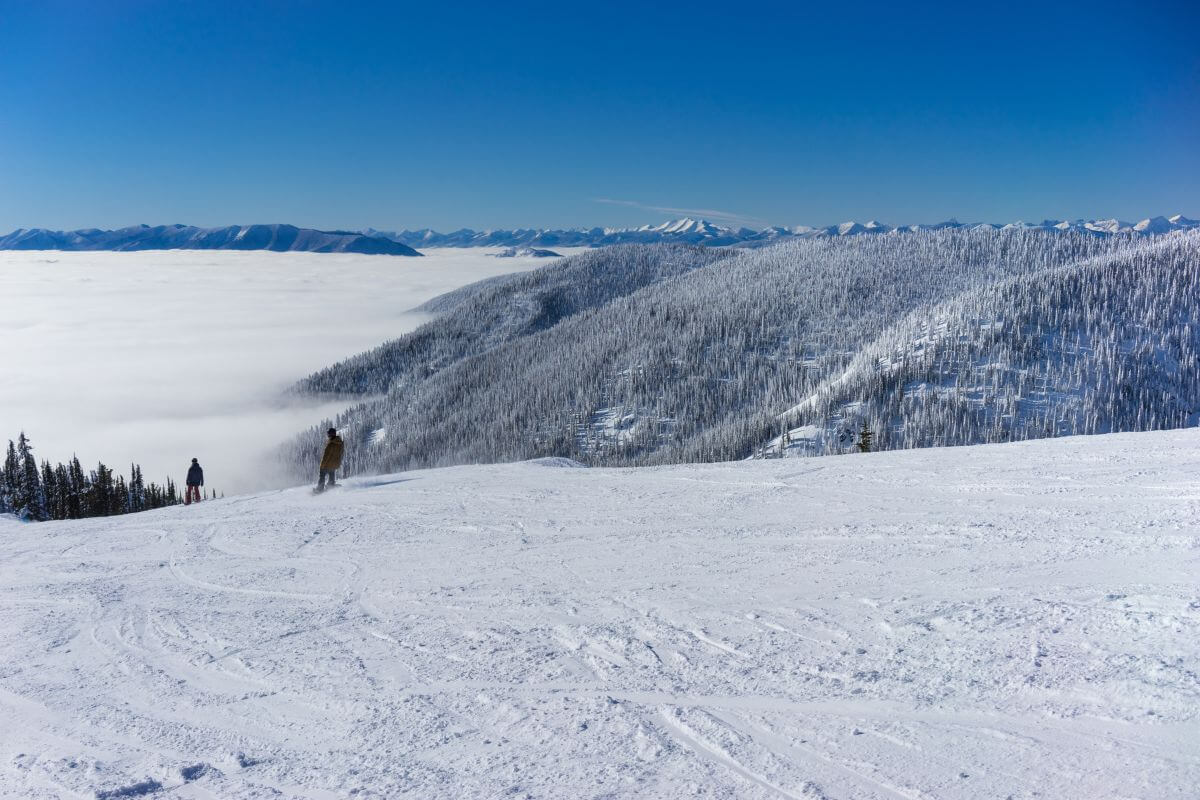 Two skiers having winter fun on a snowy slope in Montana.