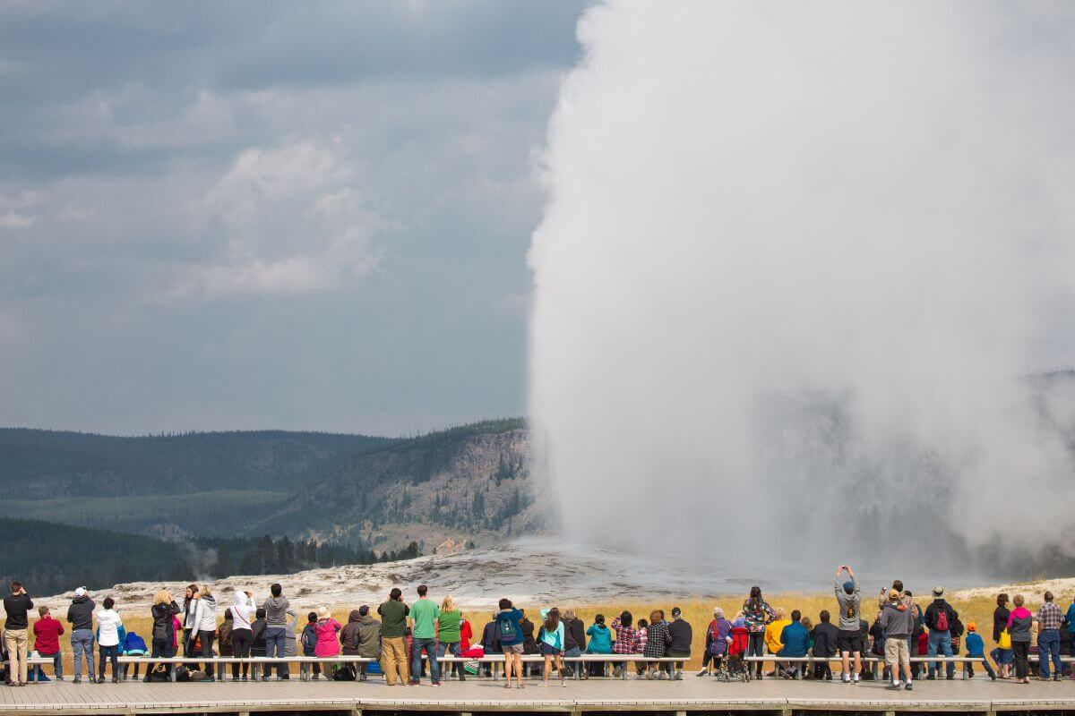 Tourists watching a geyser in Yellowstone National Park.