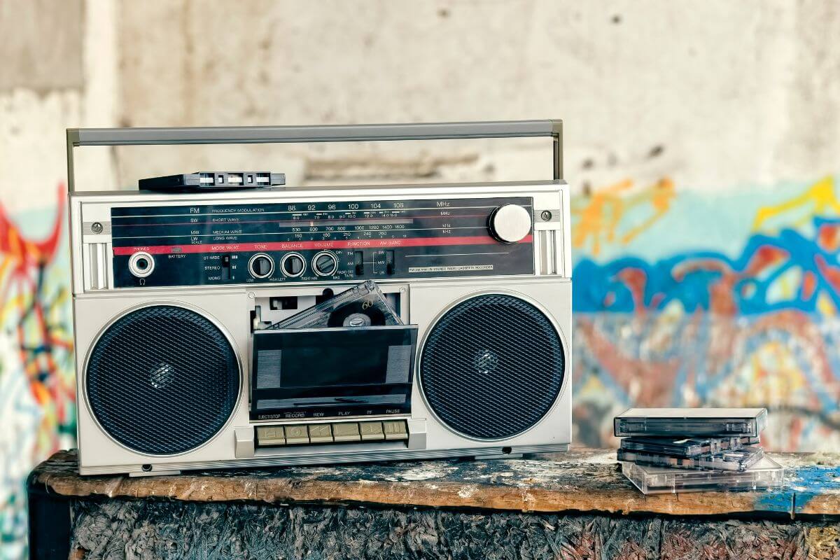 A boombox sits on top of a piece of wood.