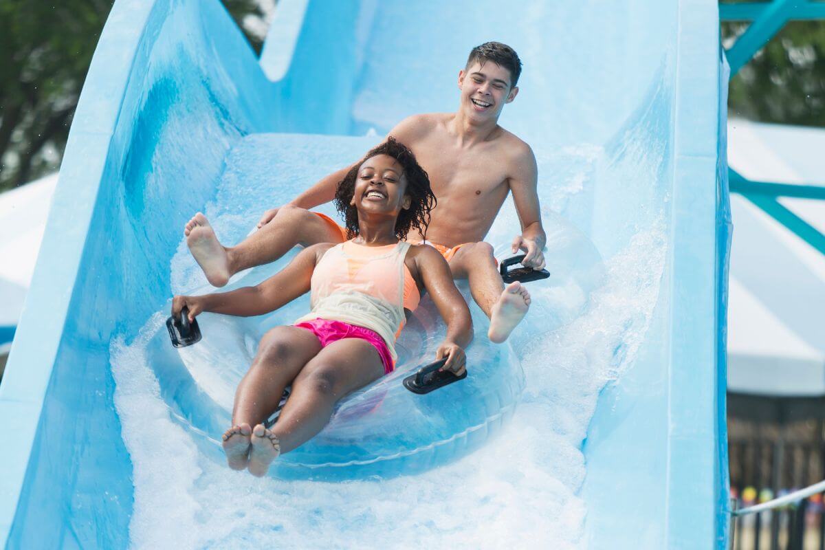 A man and woman enjoying a ride down a water slide in a Montana waterpark.