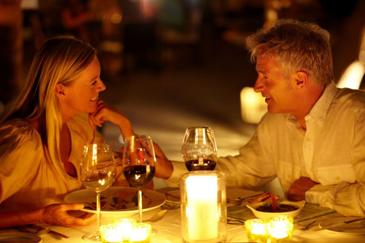 A man and woman having a dinner date during their Montana honeymoon.