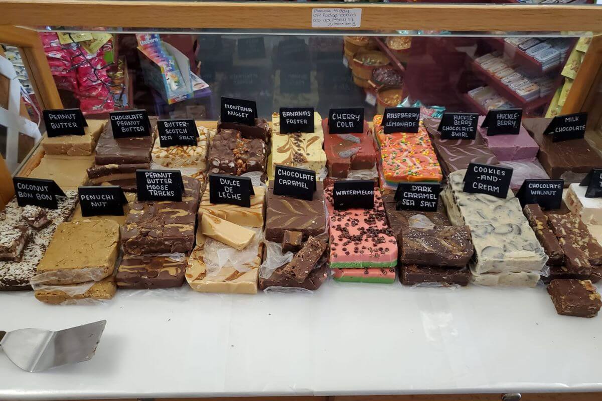 An assortment of homemade fudges displayed on a glass counter at Candy Masterpiece, one of the stops on a Montana chocolate tour.