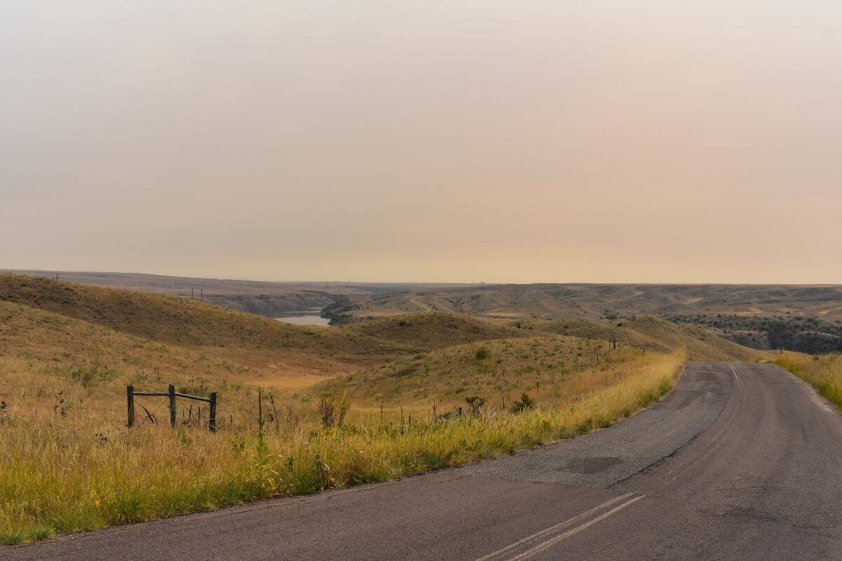 A Road Surrounded With Grassy Plains in Montana