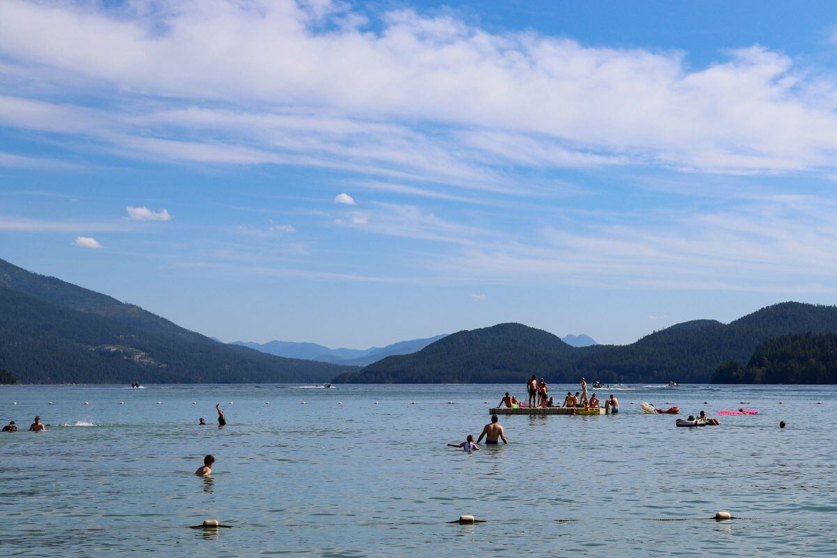 A group of people swimming in a lake in Montana