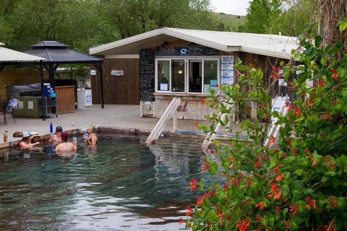 A group enjoys a dip in Norris Hot Springs in Norris, Montana