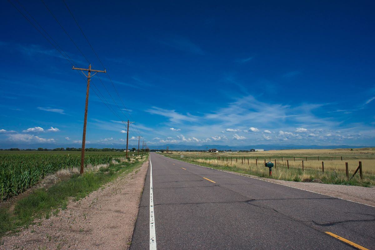An empty road and a blue sky in Montana.