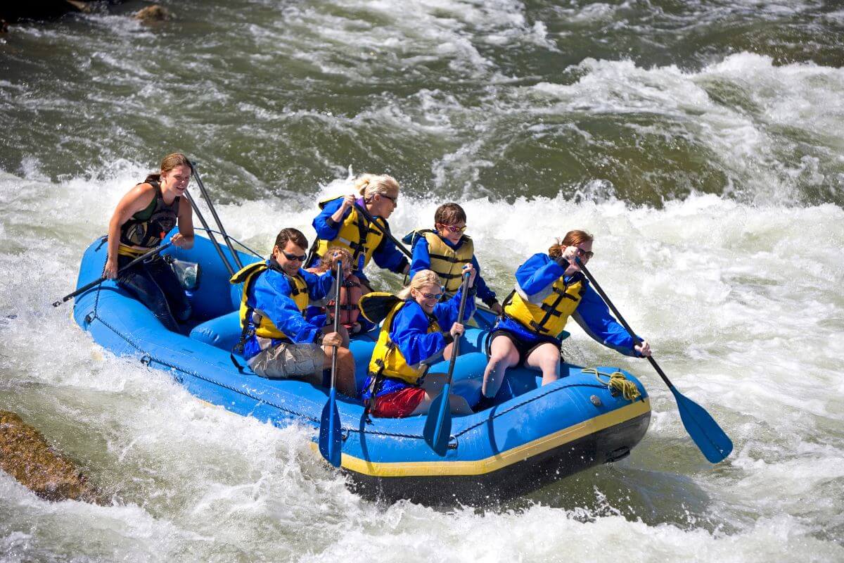 A group goes whitewater rafting in the nearby rivers to Mokowanis Cascade Falls in Montana