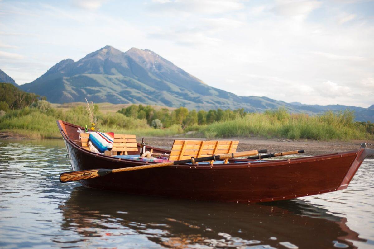 A picnic set up on an empty rowboat in preparation for a Yellowstone River boat tour.