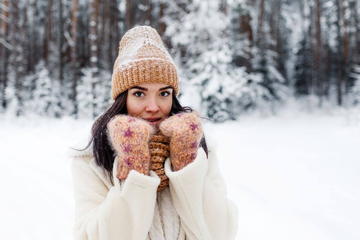 A woman wearing mittens in the snow in Montana.