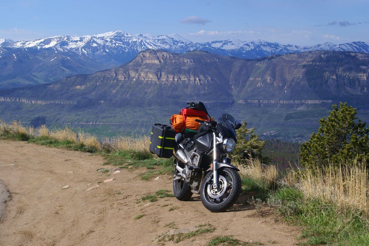 A motorcycle equipped for adventure parked on a dirt trail in Beartooth Pass, Montana.