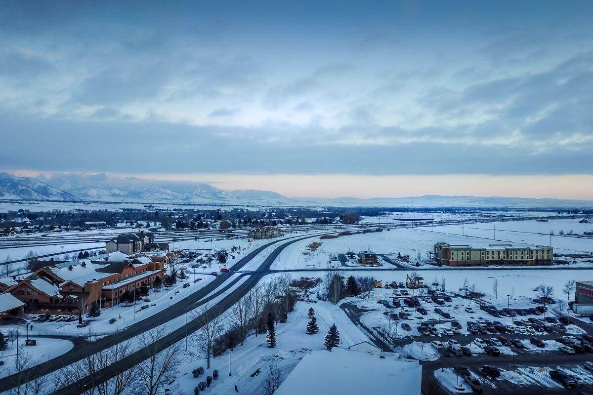 An aerial view of a city in Montana covered in snow.