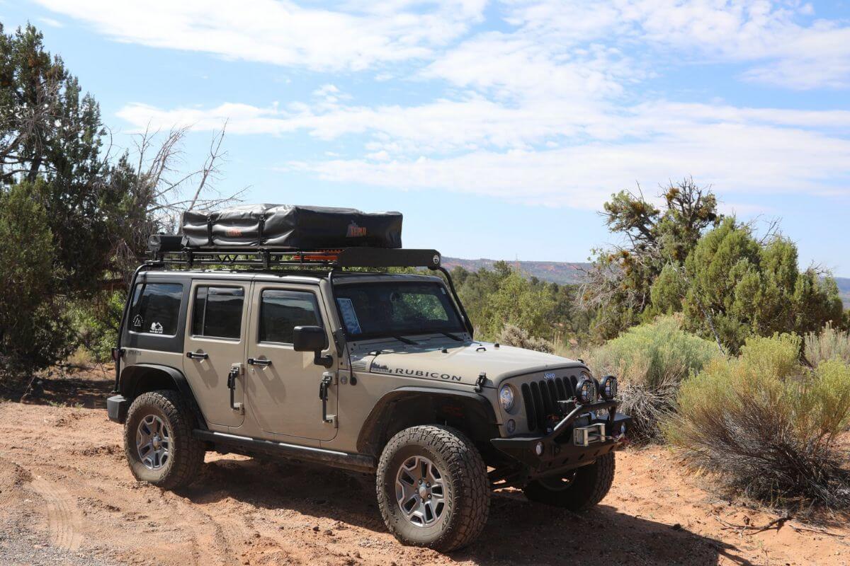 A Wrangler Rubicon from Glacier Nomadic Adventures parked on a desert trail, ready for a Montana jeep tour.