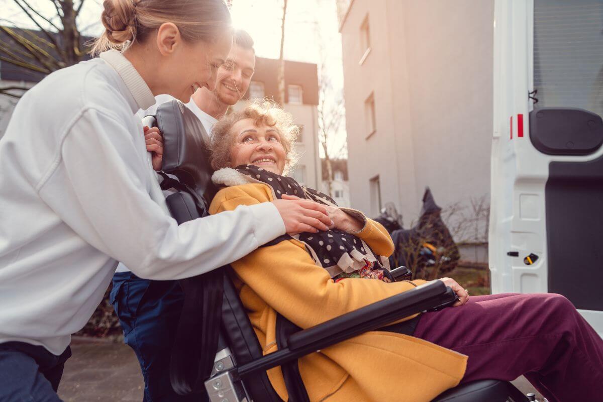 A Woman in a Wheelchair Being Helped by Caregivers in Montana
