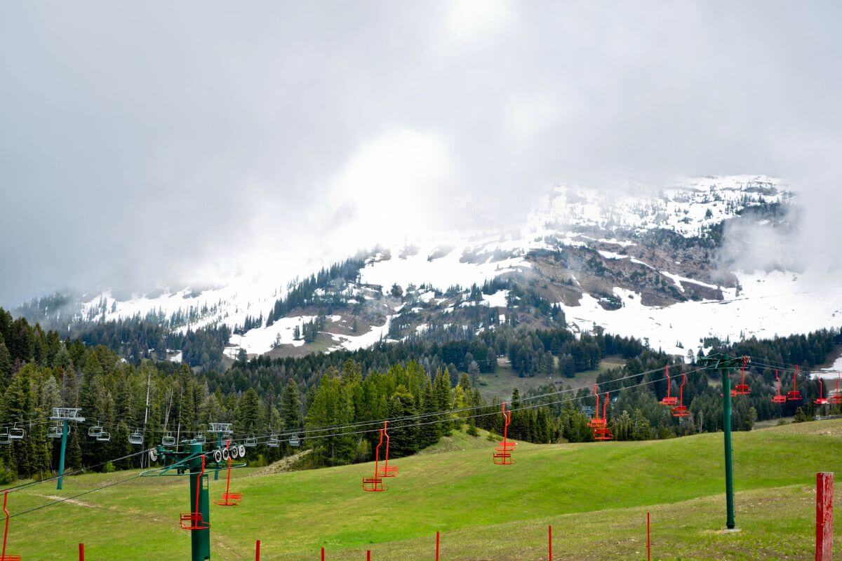 A scenic chairlift with a magnificent mountain in the background, offering an exhilarating experience for those seeking exciting things to do in Montana during fall.