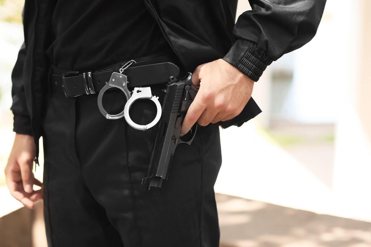 Man with Handcuffs Pulling a Gun