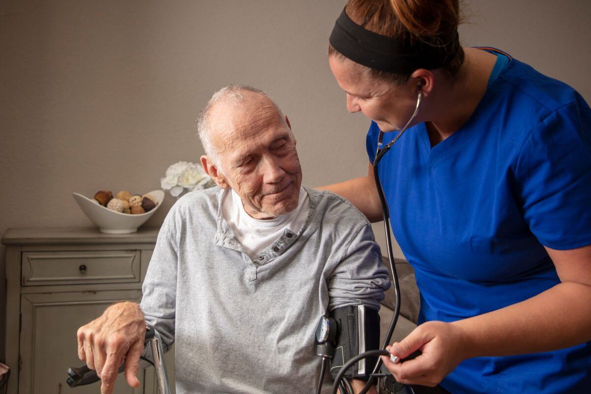 Female Nurse Checking an Elderly's Blood Pressure