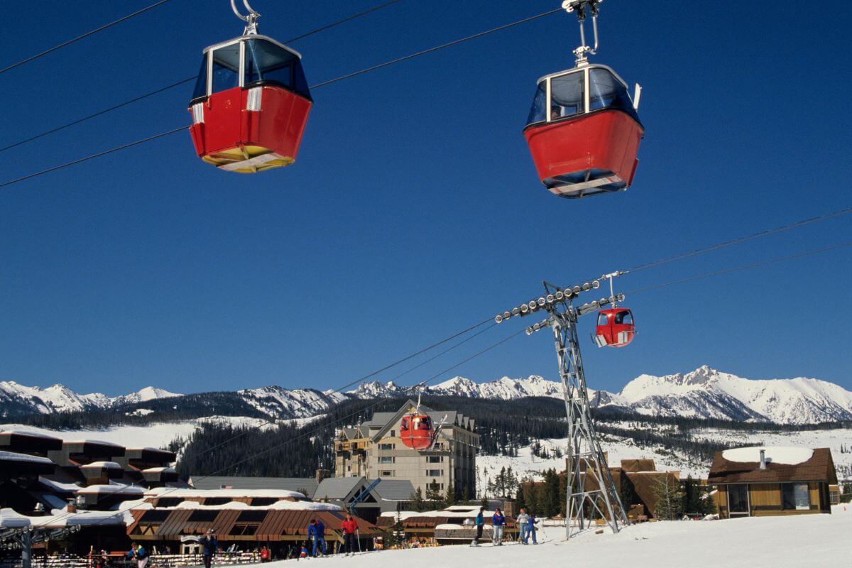 Two red gondolas on a ski slope in Montana.