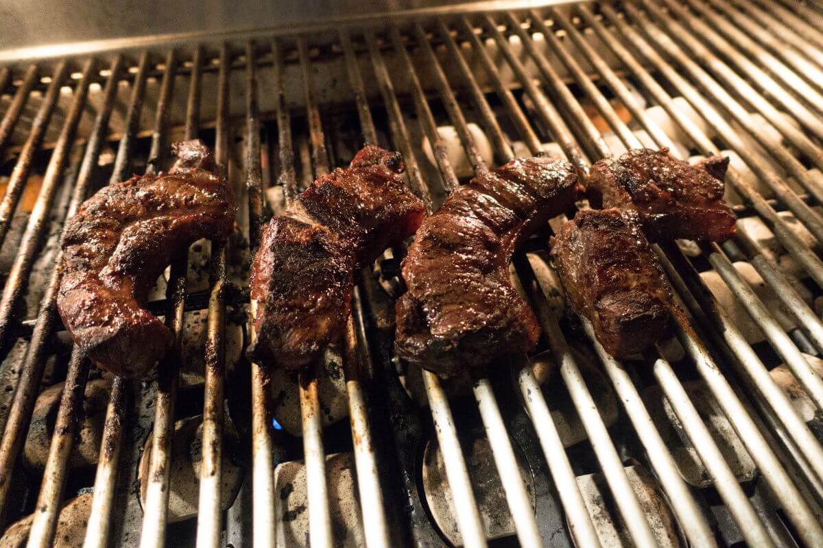 Steaks are being cooked on a grill in Montana.