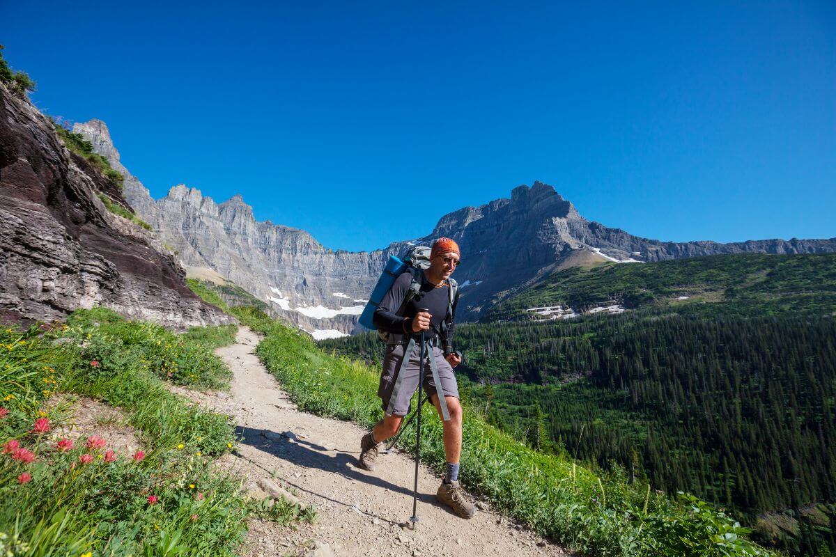 A man hiking on a trail in Glacier National Park.