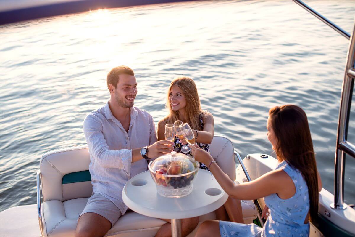 Three People Cheering and Drinking in a Yacht