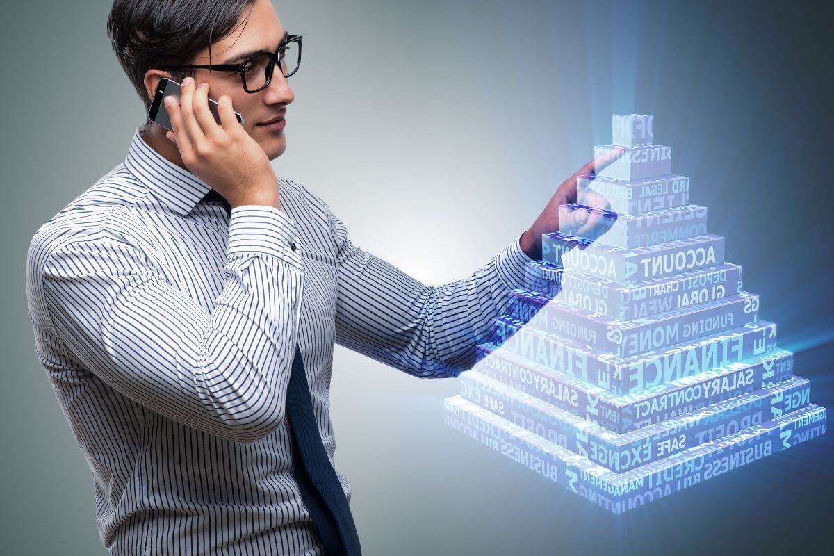 Man on his Phone Presenting a Digital Business Pyramid 