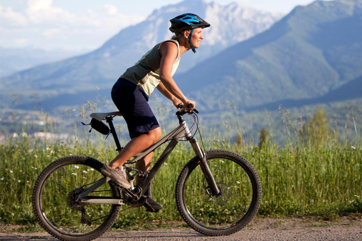 A woman bikes on a dirt trail in Lolo National Forest in Montana
