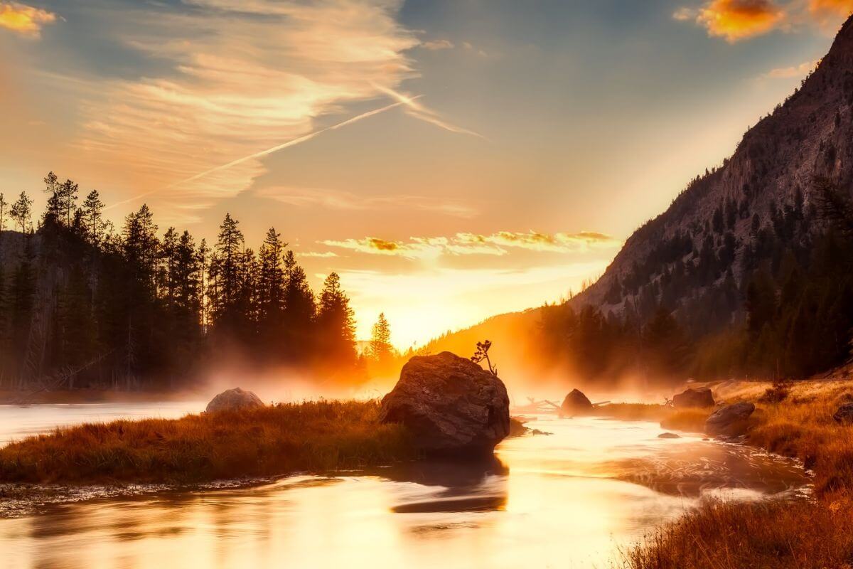 Sunrise over a river in Yellowstone National Park.