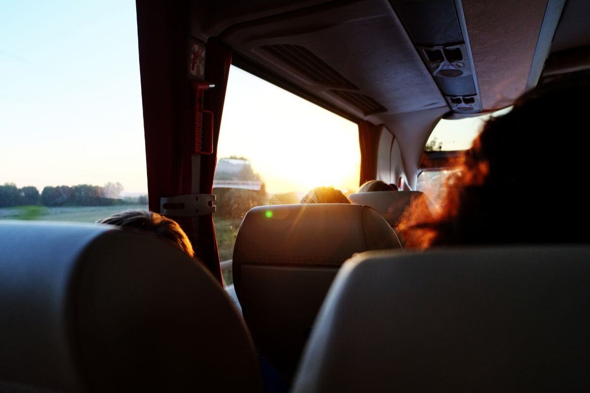 Travelers sitting in the back of a bus at sunset, exploring Montana.