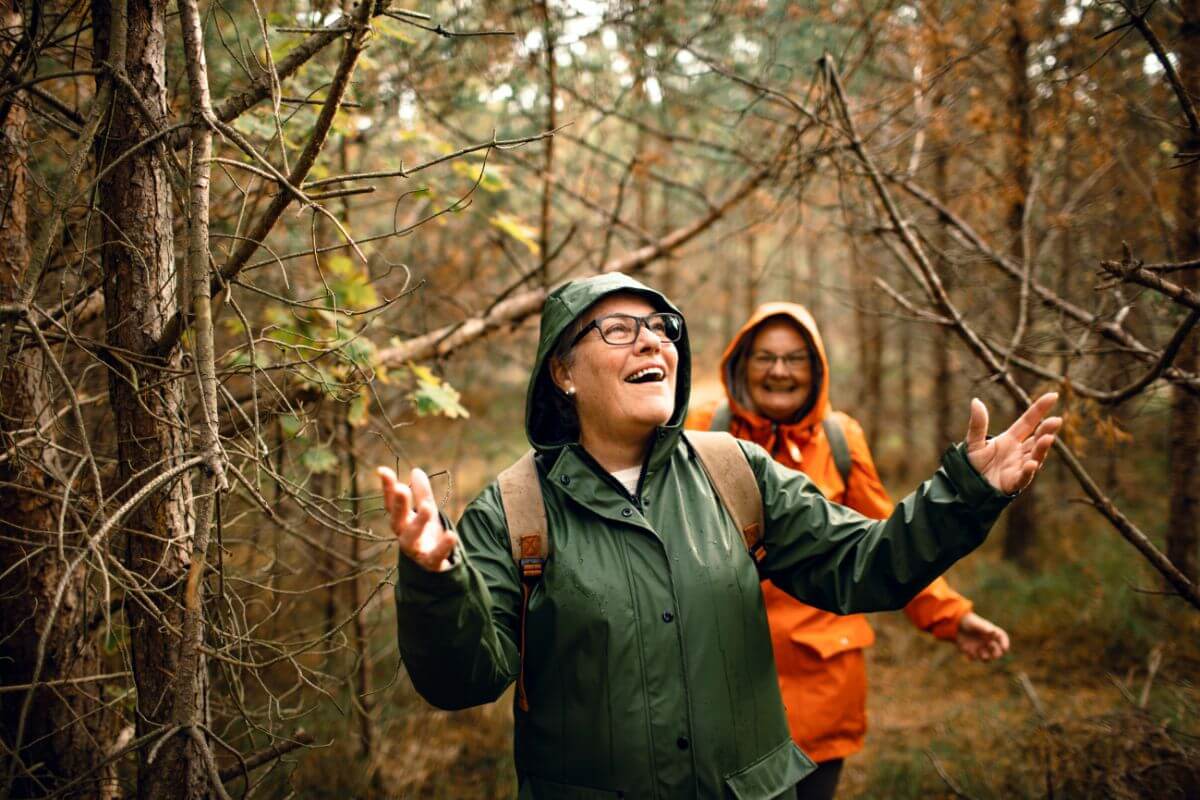 Two hikers share a joyful moment in the woods near Impasse Falls.