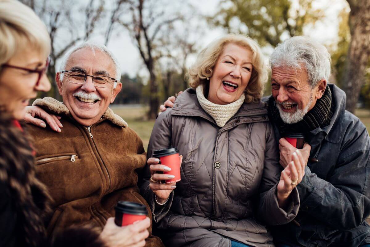 A group of senior people laughing and drinking coffee in Montana.