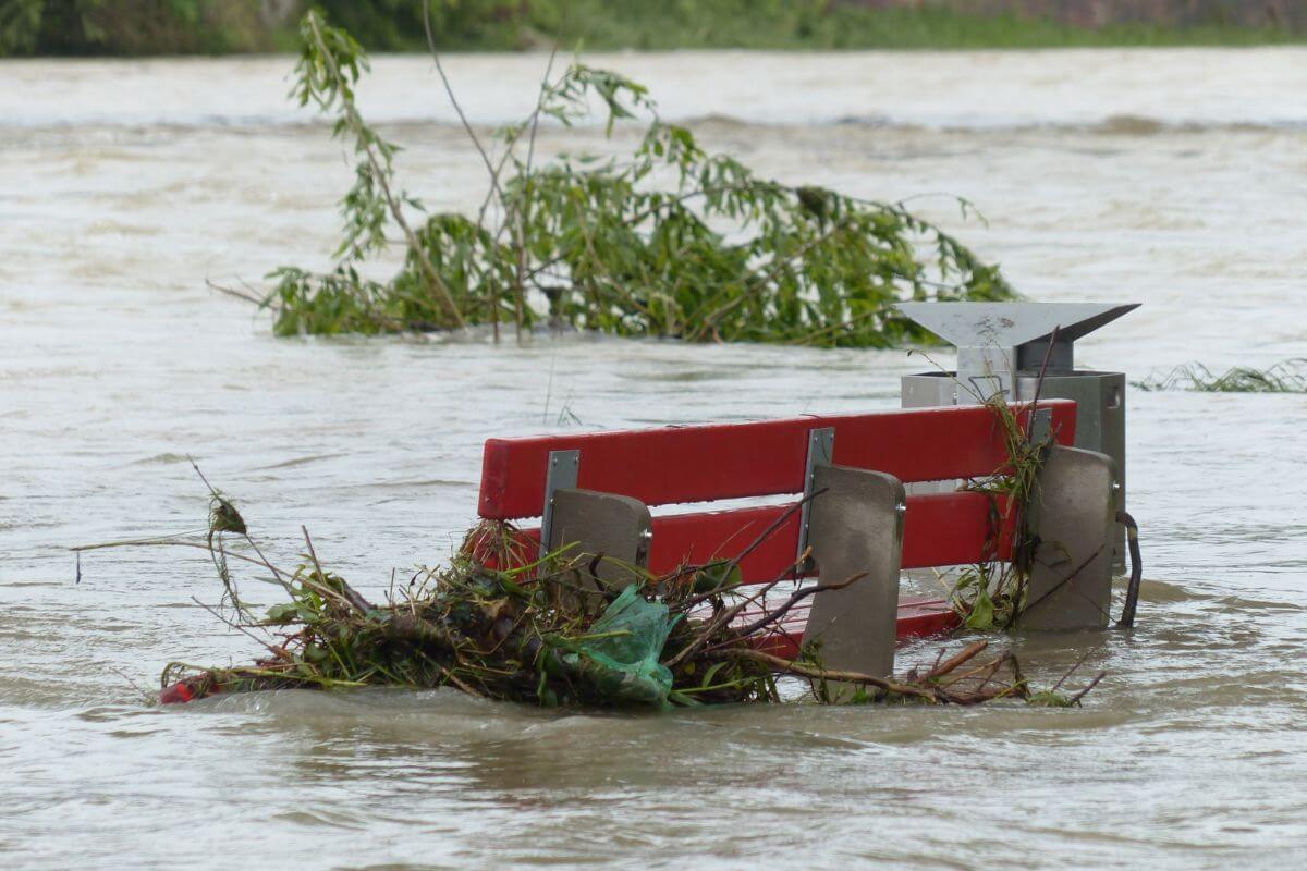 A red bench sticks out from a flooded area in Montana