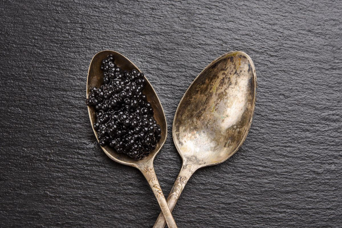 Two Golden Spoons with Caviar on One of Them