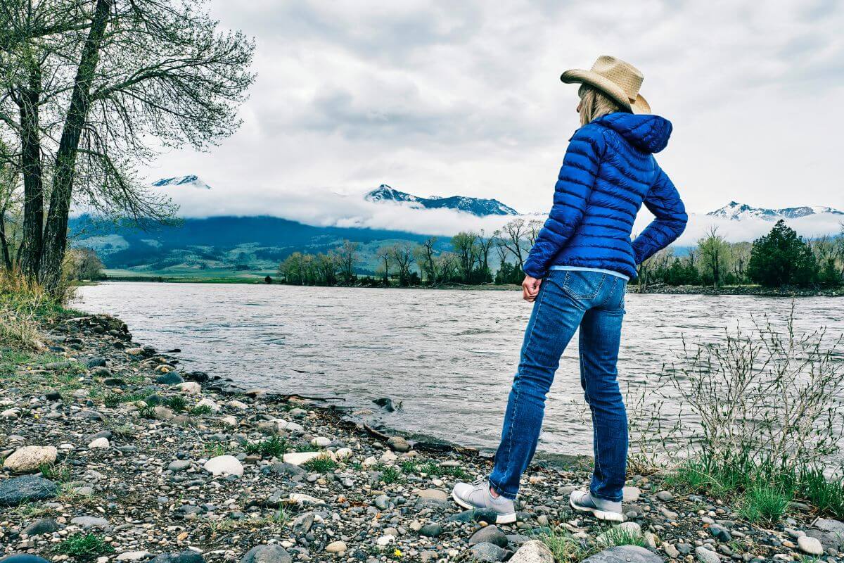 Woman Standing on a Riverbank in Paradise Valley Montana