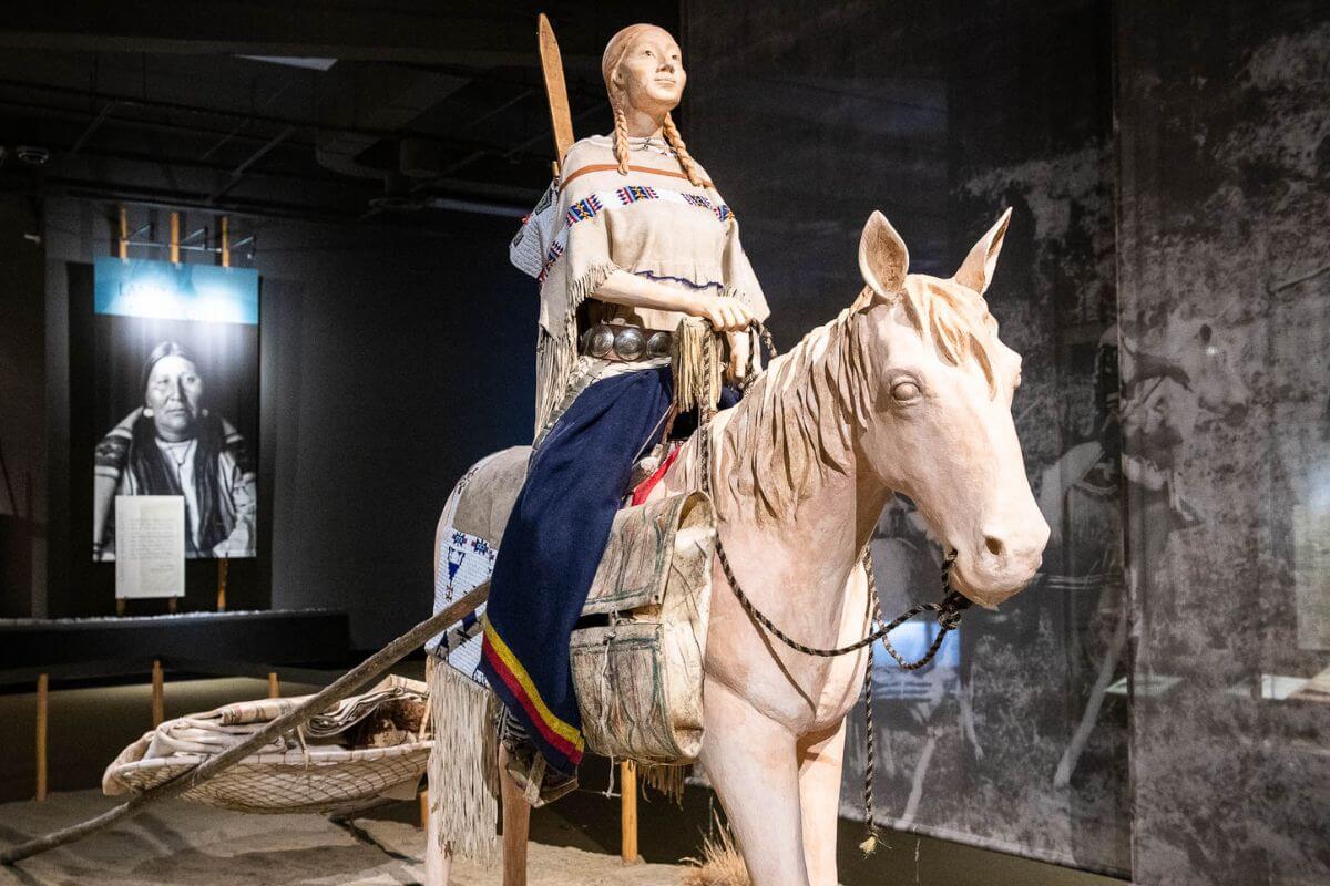 An exhibit featuring a Native American woman on horseback at Museum of the Plains Indian
