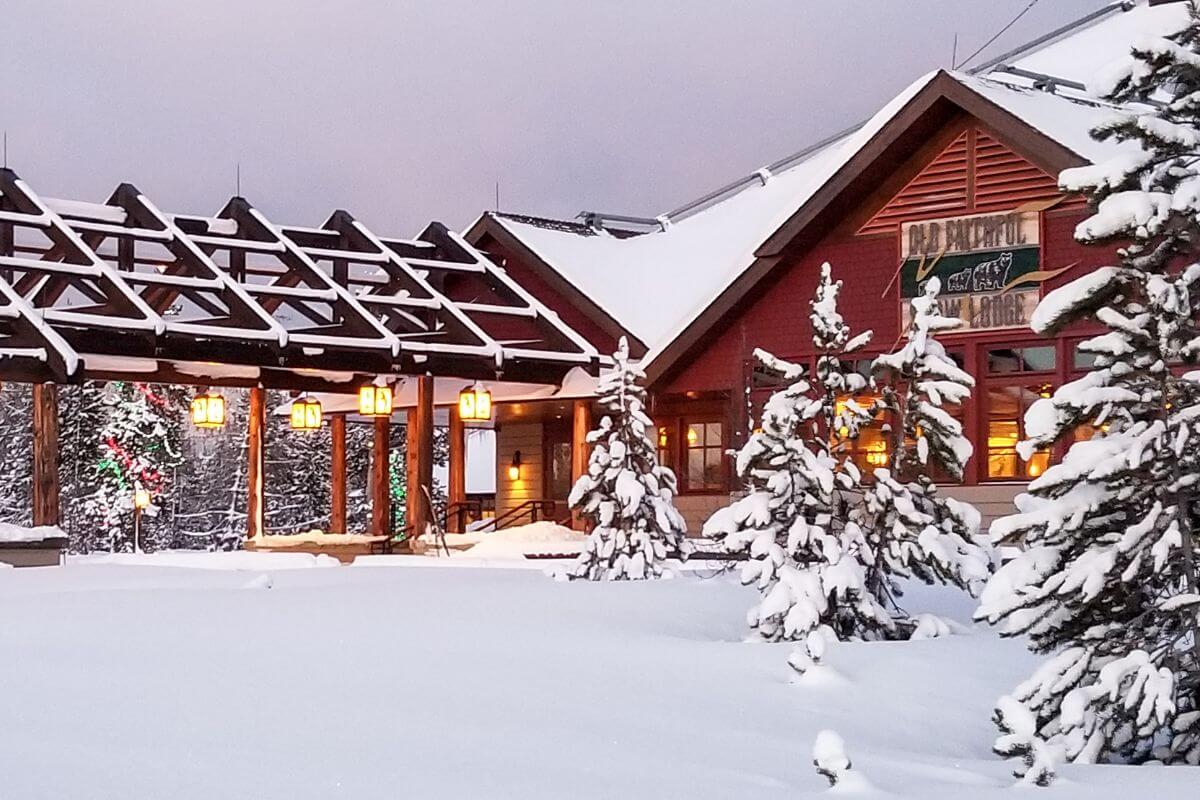 Old Faithful Snow Lodge nestled amid snow-covered trees in Montana.