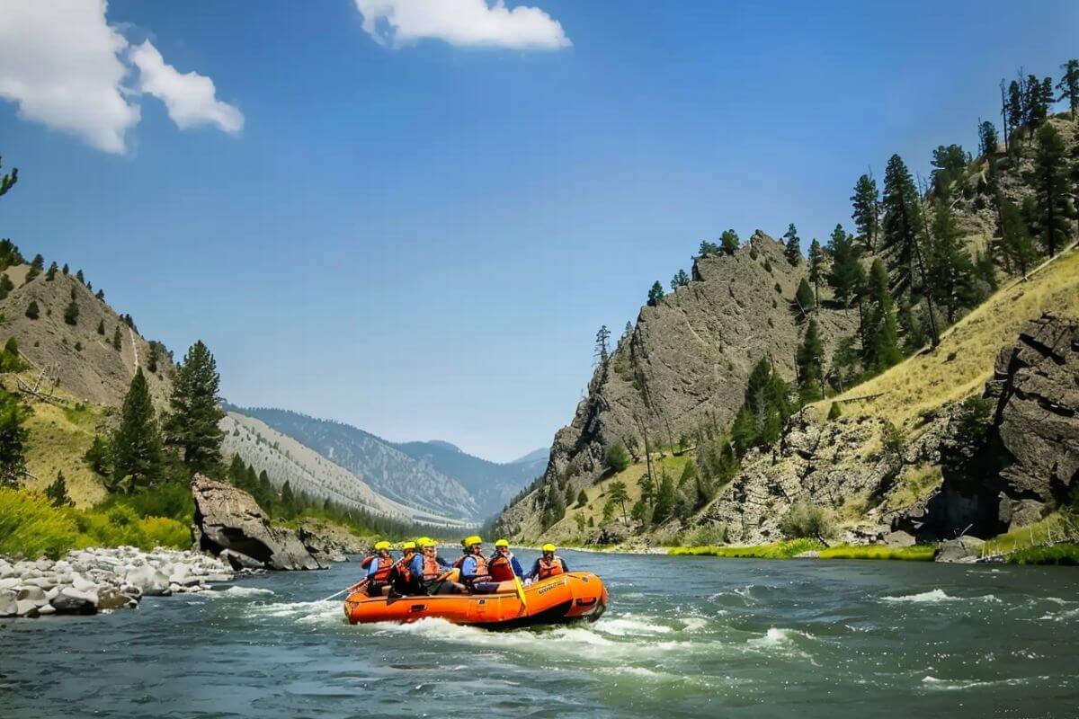 A group of people enjoying a rafting adventure at the Yellowstone River.