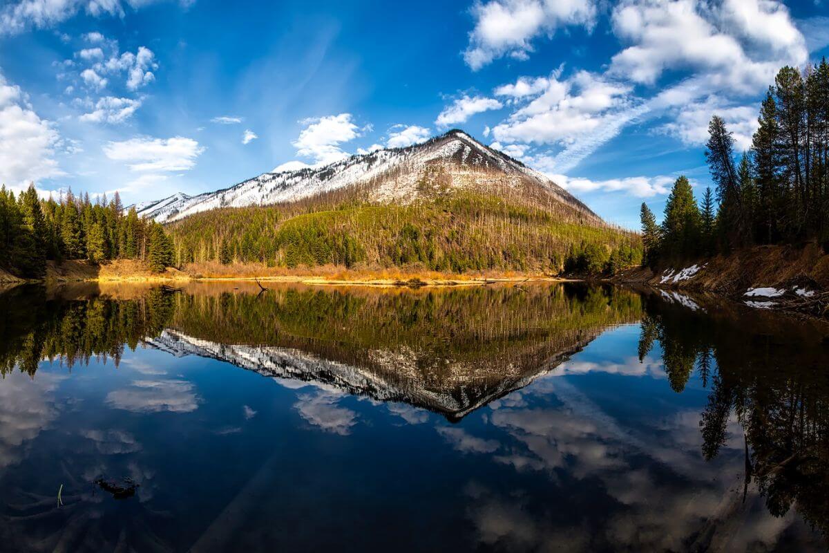 A lake reflects a mountain range in Montana