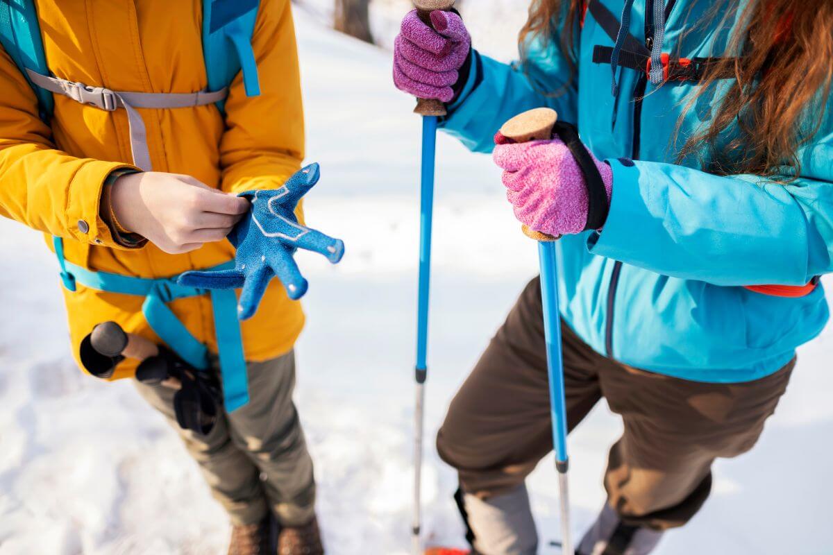 Two people holding ski poles in the Montana winter weather.