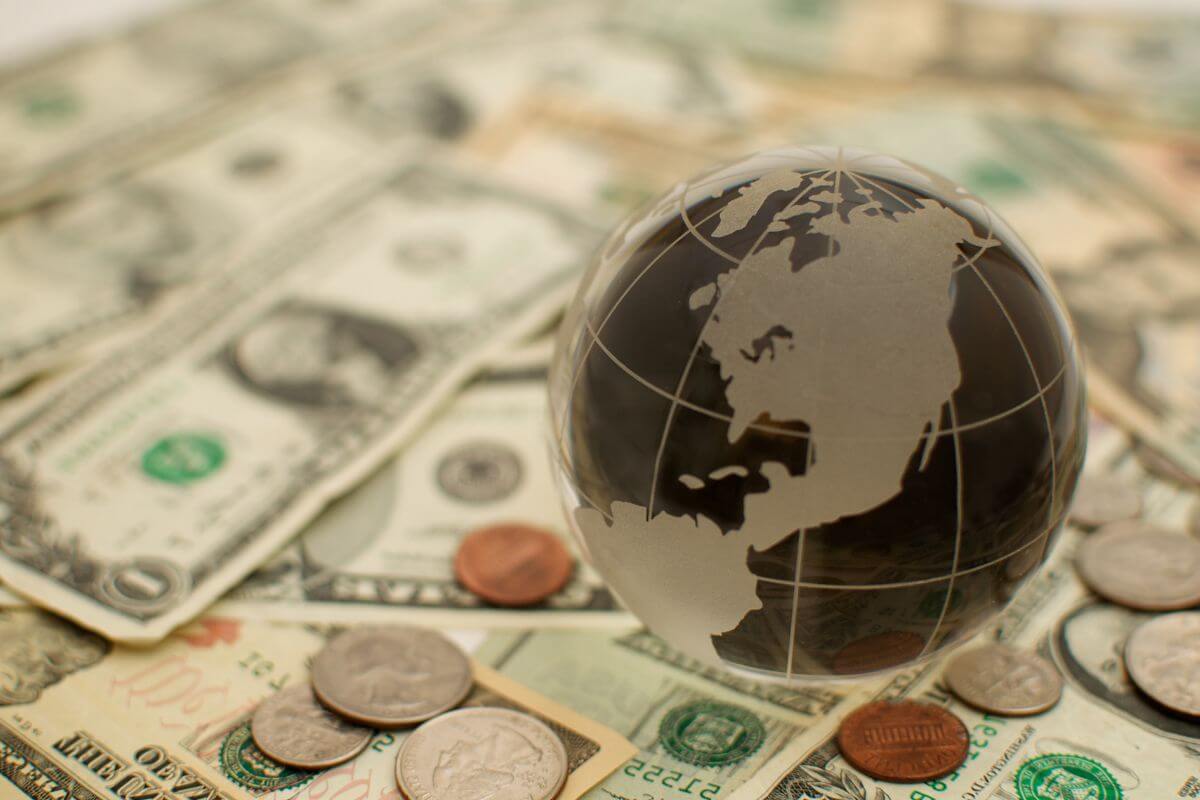 A globe sits on top of money