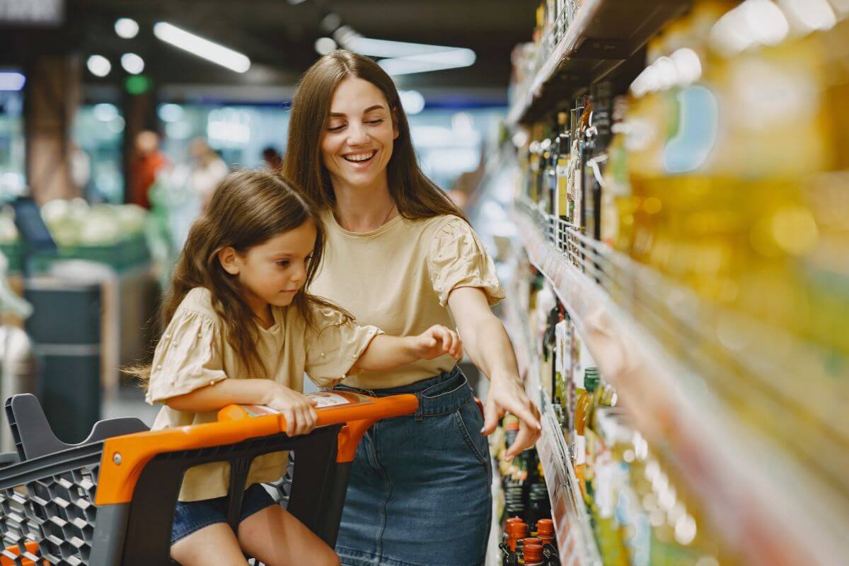 Girl with Mother Buying Groceries
