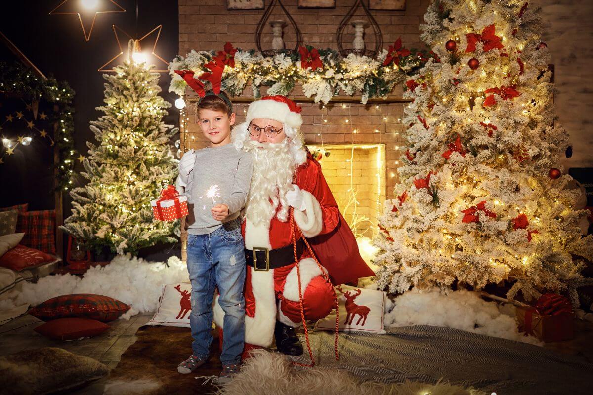 A boy and Santa Claus posing in front of a fireplace during a Christmas in Montana.