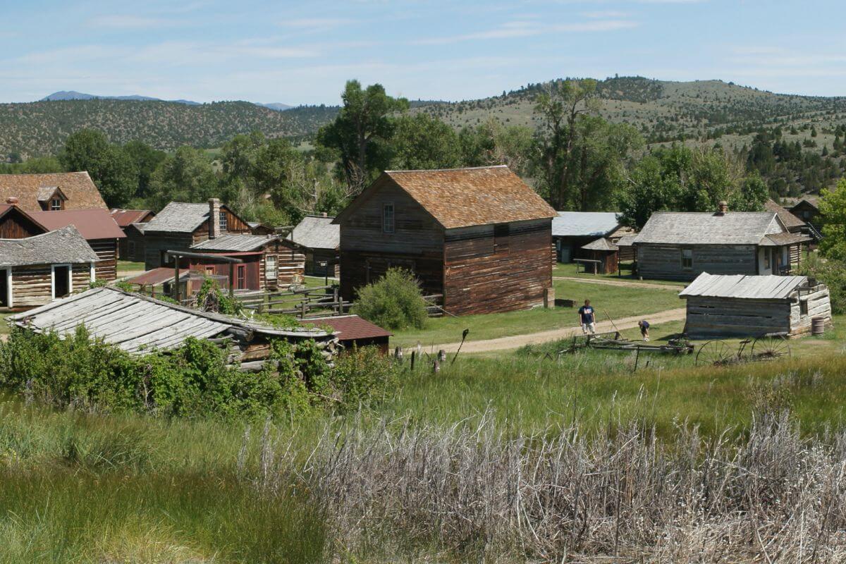 A view of an old ghost town in Montana under clear blue skies.