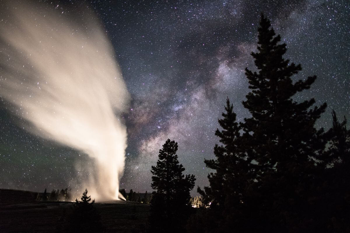 An enchanting geyser in the night sky.